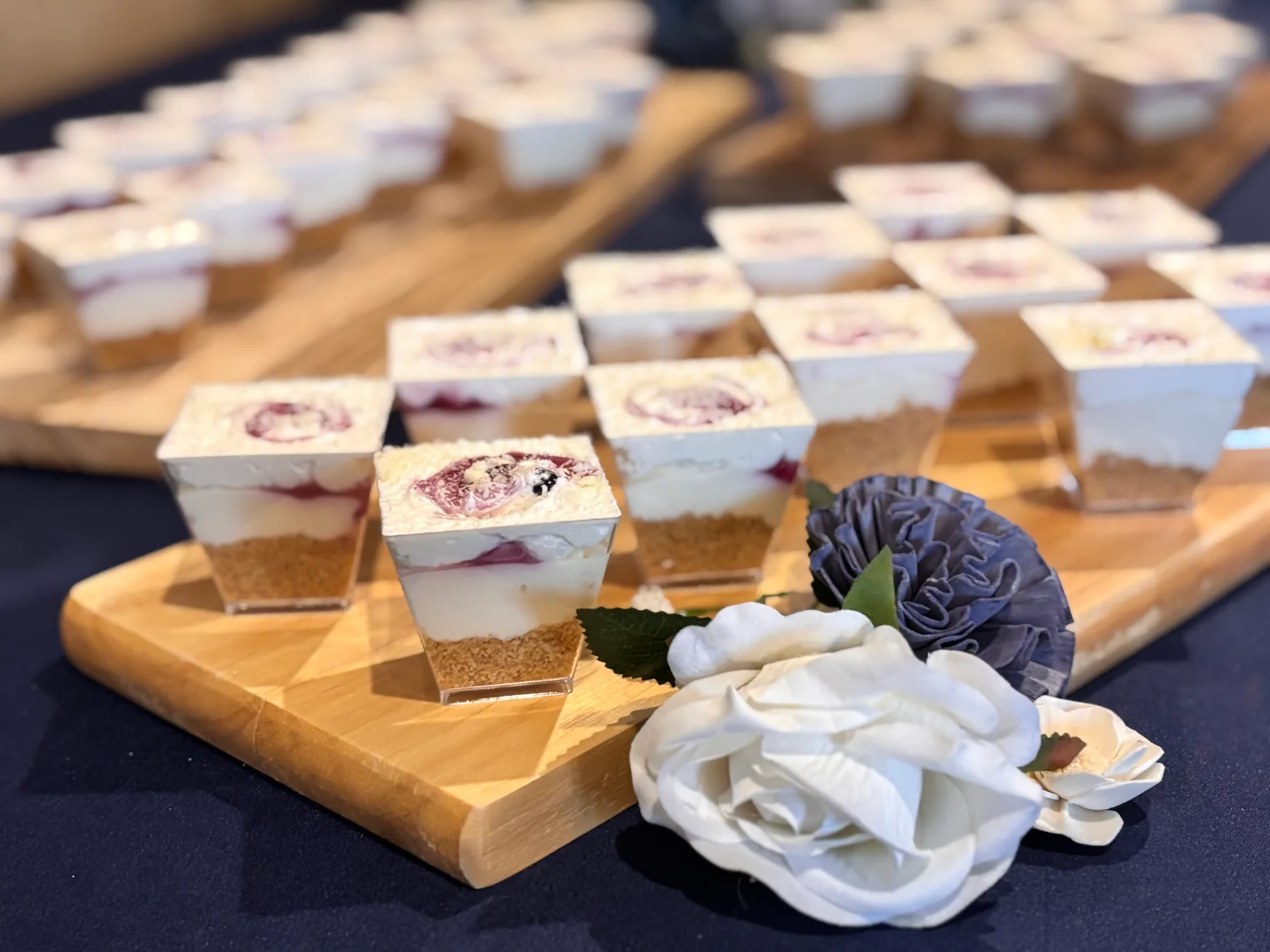 Individual desserts arranged on wooden serving boards