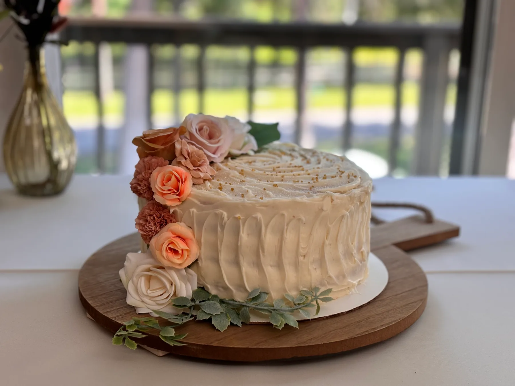 A small celebration cake decorated with delicate flowers